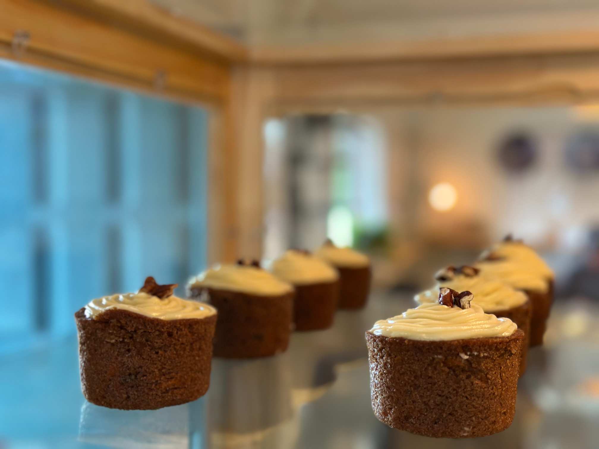 A display case with carrot cupcakes