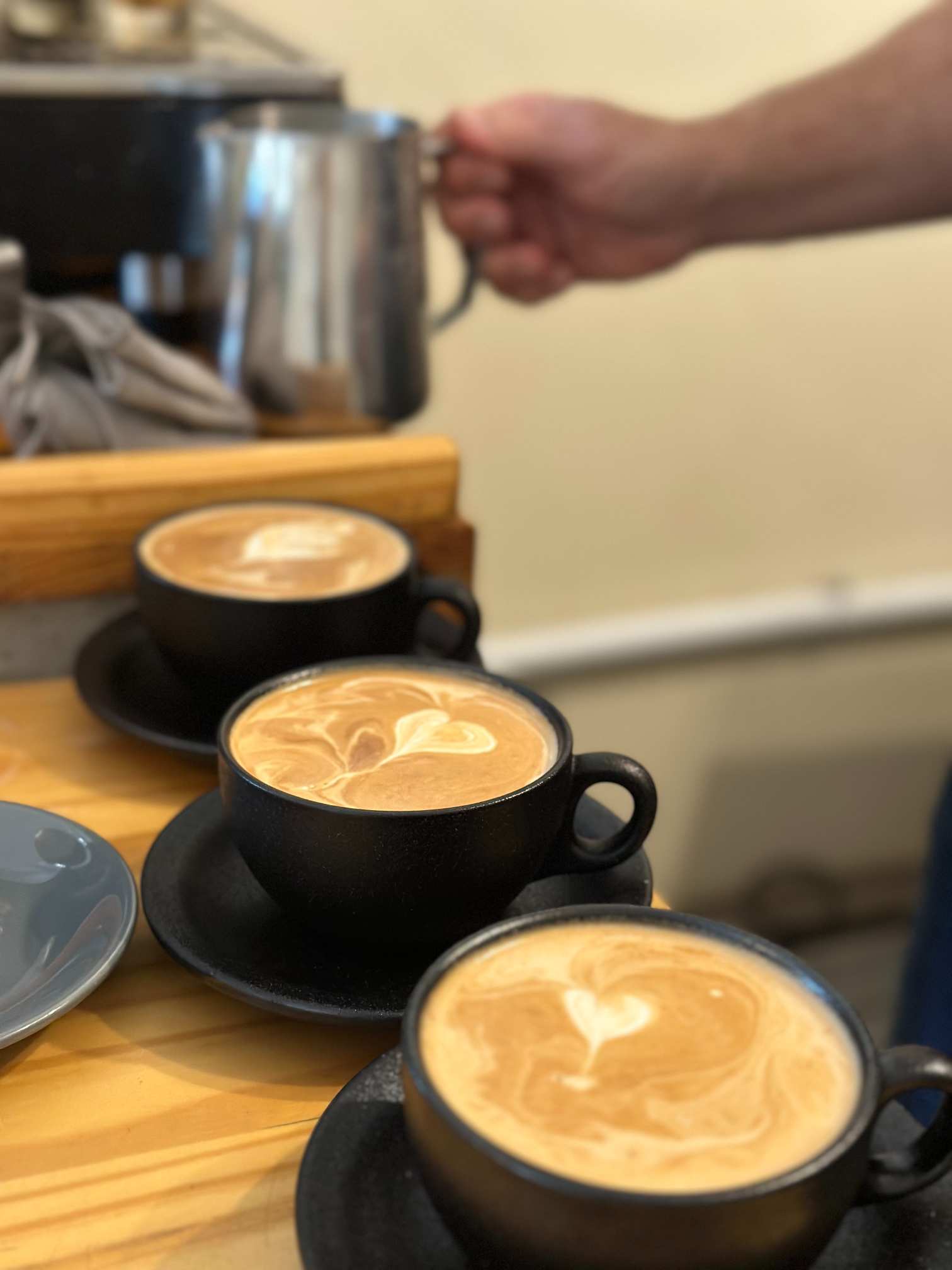 3 cups of coffee being prepared