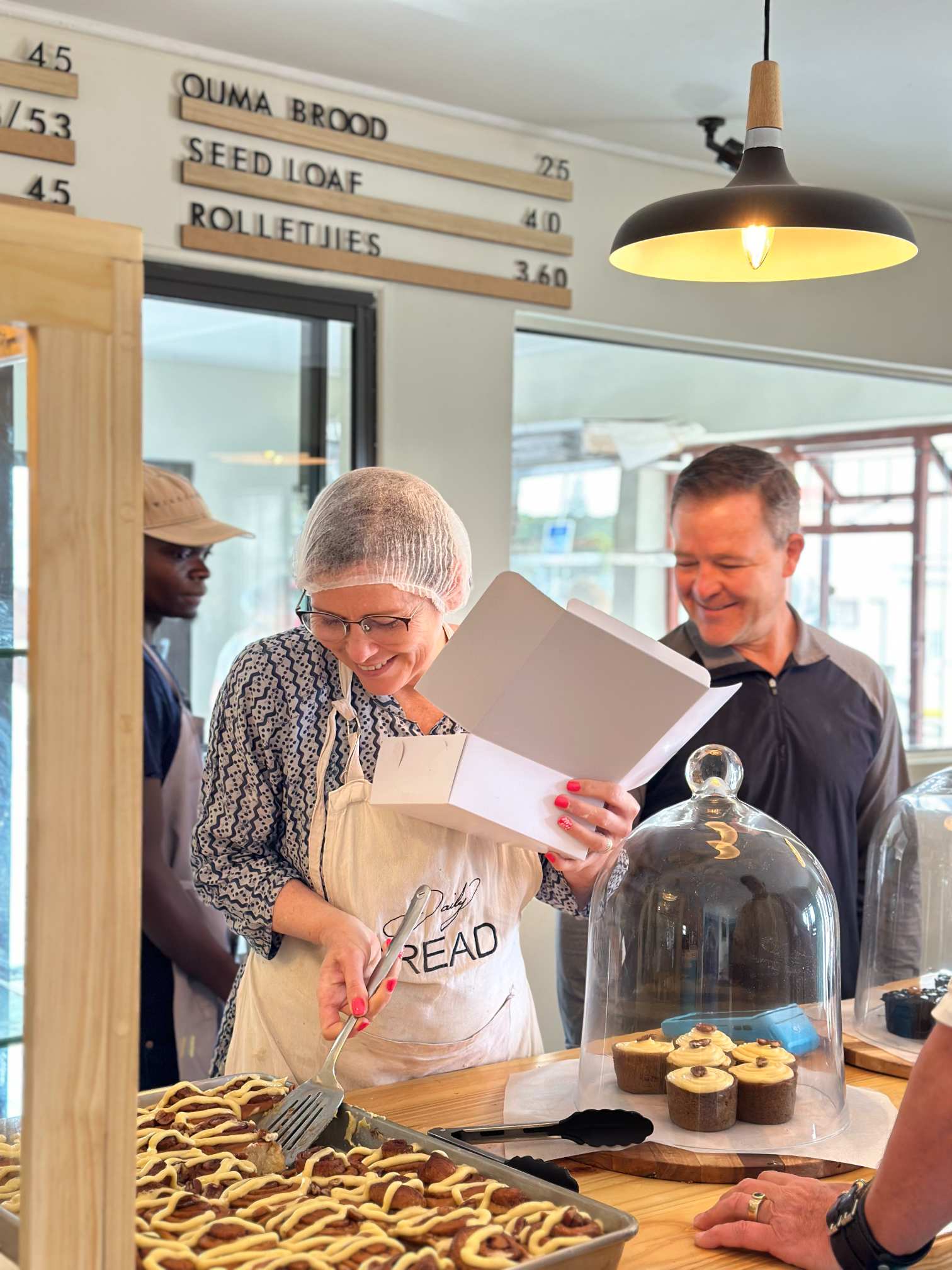 Lorraine and Izaak serving Cinnamon Rolls